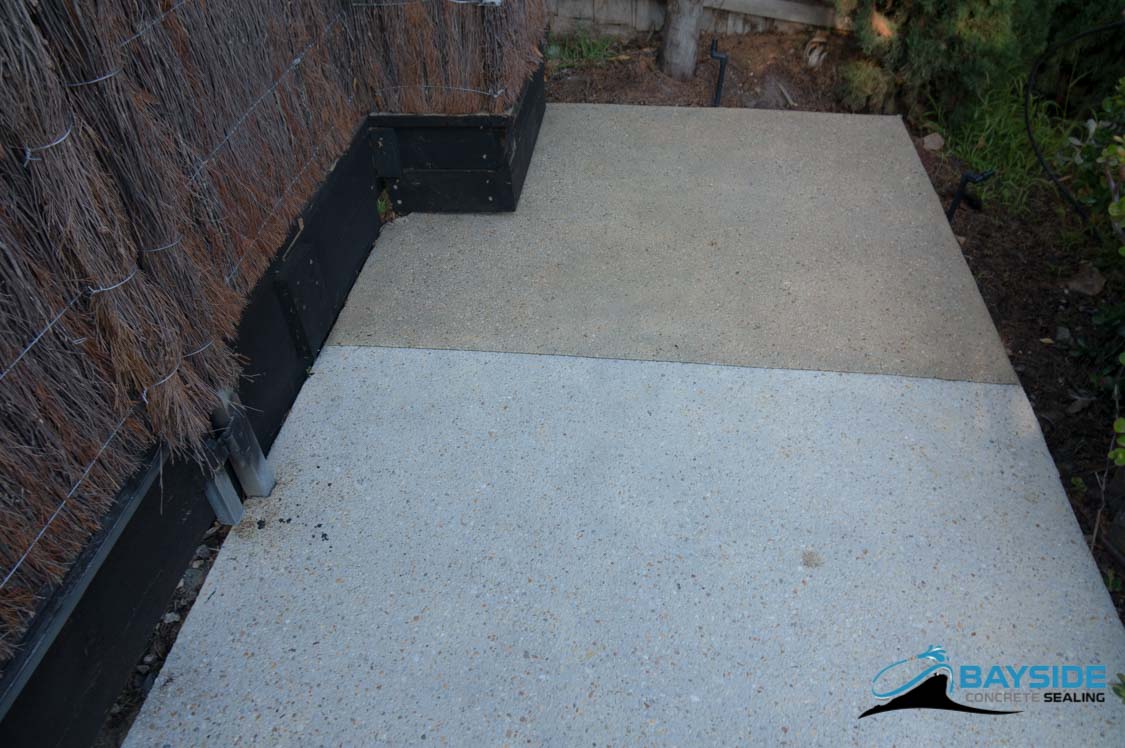 Colour-enhanced exposed aggregate with rustic tint finish on a Melbourne driveway