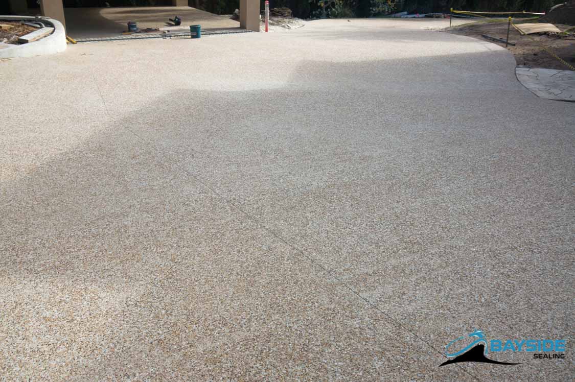 Sealed exposed aggregate driveway with enhanced stone colour